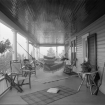 Porch with hammocks strung out, chairs & rugs, miscellaneous sports equipment Box 14, Andrew Tanner Photographs