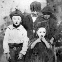 Children in masks circa 1900