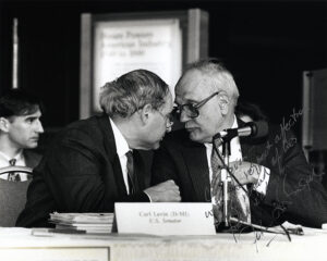 Carl Levin and John Dingell confer in Congress