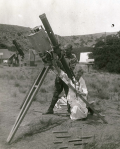 Harriet Williams Bigelow seated, preparing to look through a telescope