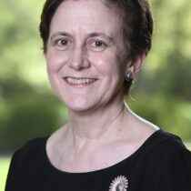 Nancy Bartlett smiling against green background