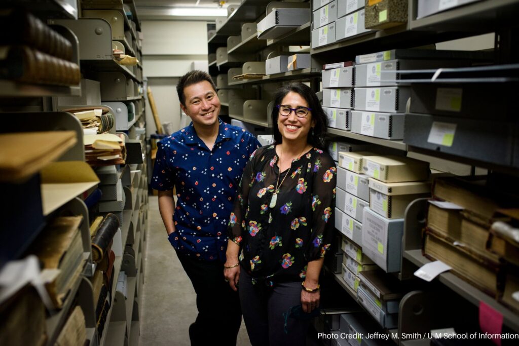 Ricky Punzalan and Deirdre de la Cruz among boxes and files in the archive. 