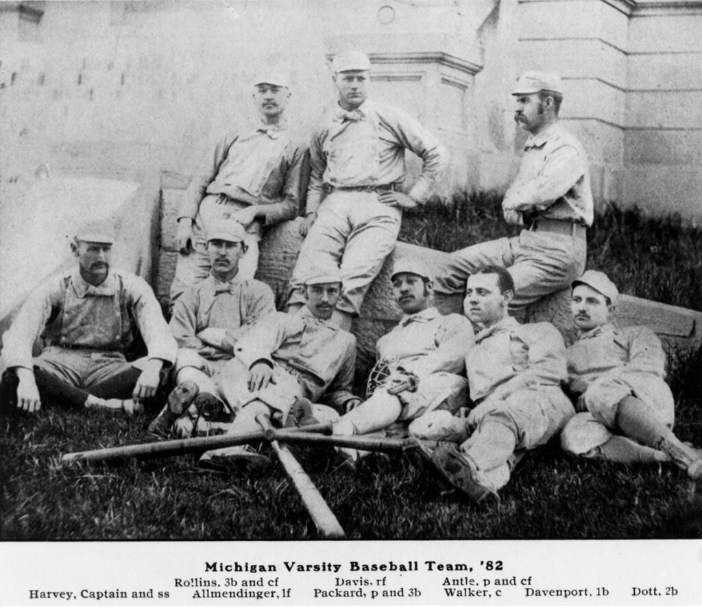 Black and white photo from 1882 showing men in uniforms, some holding baseball bats.