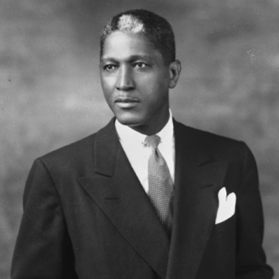 Black and white image of an African American man wearing a suit and tie