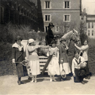 Women athletes posing in front of the Martha Cook dormitory.