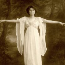 Poet Angela Morgan poses in a long white dress.