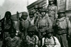 John Nakamura and a group of other soldiers in Basic Training in 1944. John is at the far left of the front row.