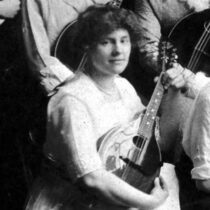 A woman holding a mandolin.