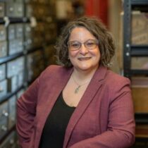 Alexis Antracoli, Director of the Bentley Historical Library, standing in the stacks at the historical library.