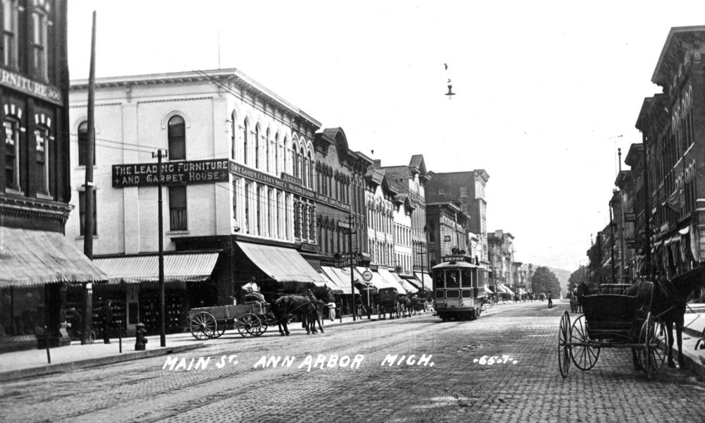 An electric streetcar on South Main Street in Ann Arbor circa 1908, featuring buildings, a street, and an electric streetcar.