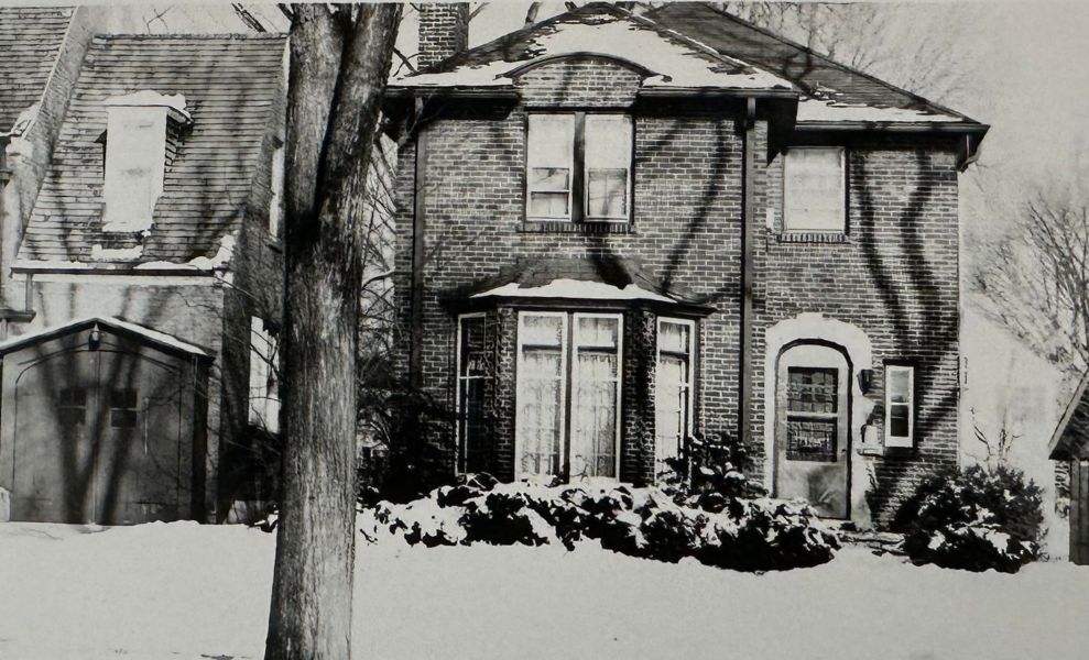 House designed by Bertha Whitman, 3205 Hartzell, Evanston, Illinois, featuring an arched door, bay window, and brick walls.