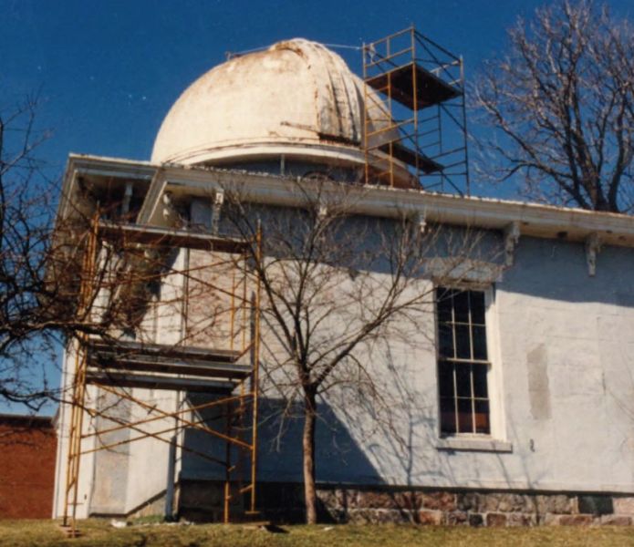 The Detroit Observatory receiving much-needed repairs in the mid 1980s, featuring the domed observatory building and repair scaffolding.