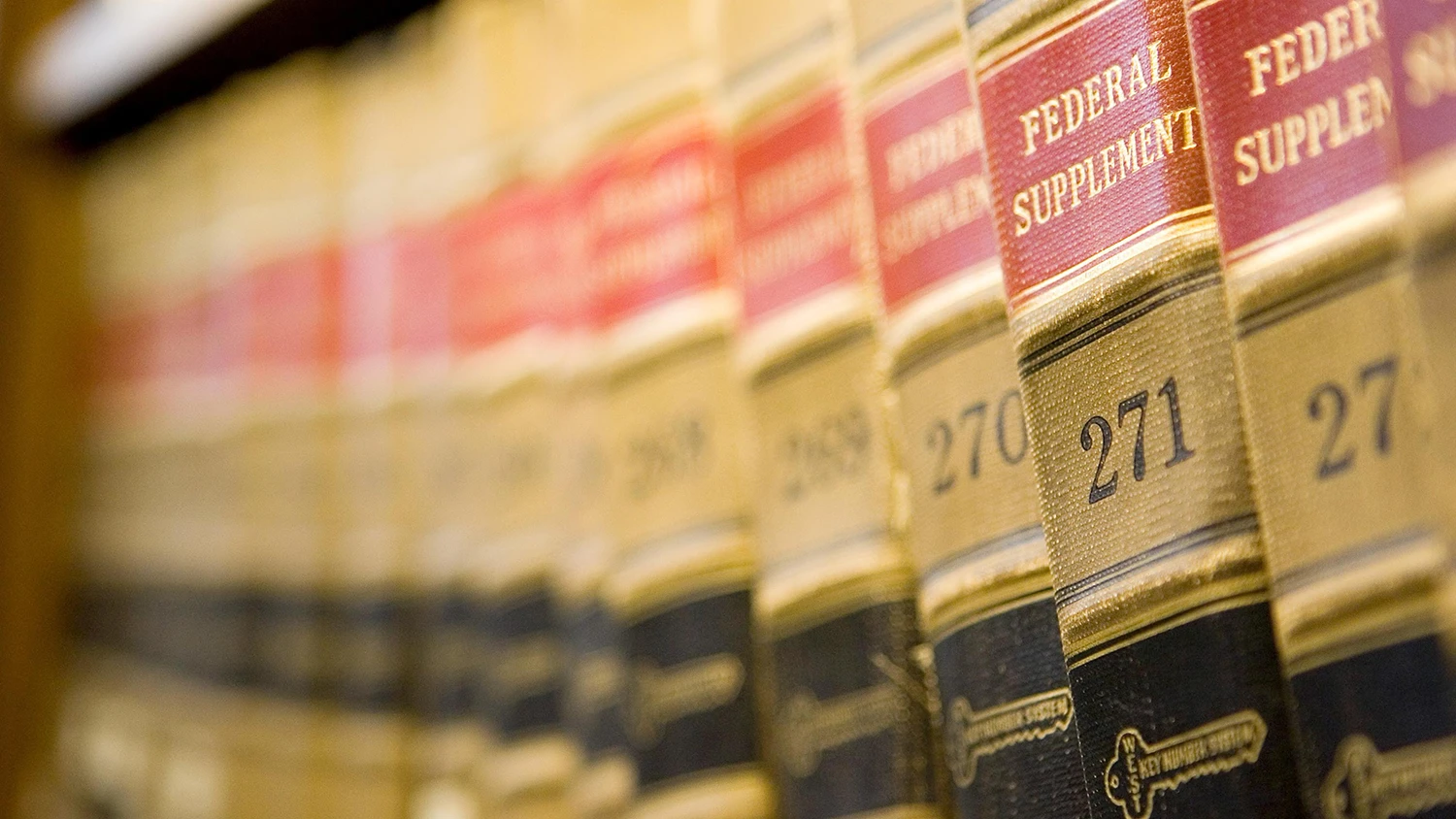 A row of shelved law books in a library.
