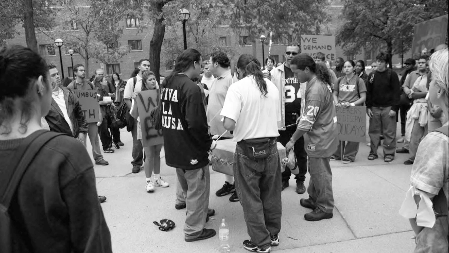 Native American U-M students play a drum during a protest against Columbus Day.
