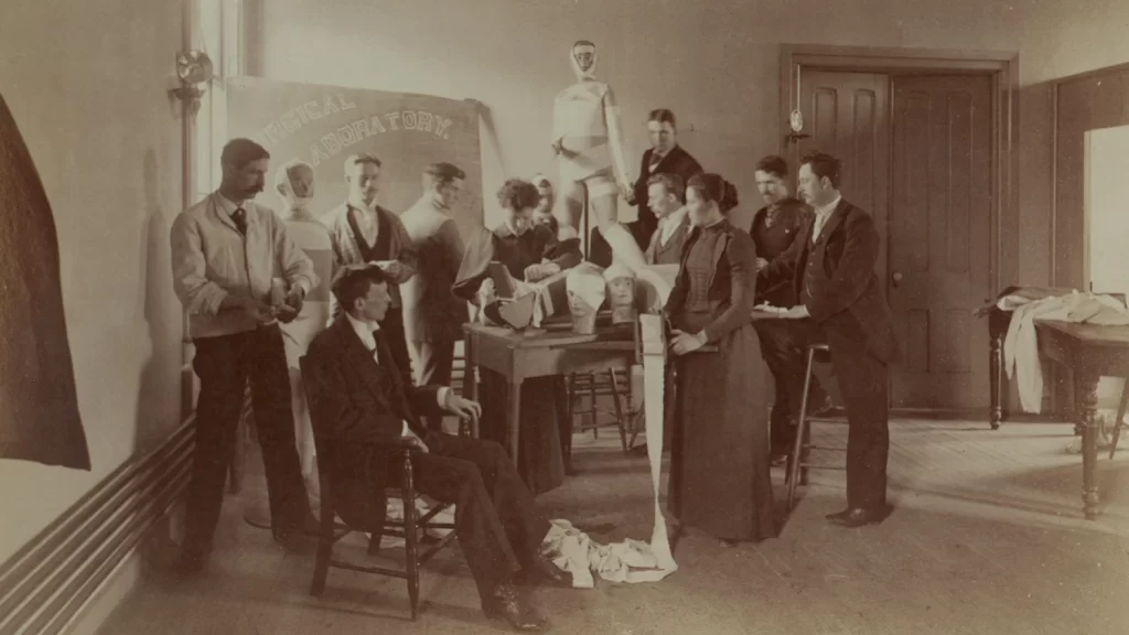Medical students practicing bandaging dummies.