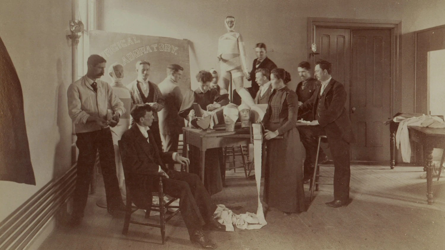 Medical students practicing bandaging dummies.
