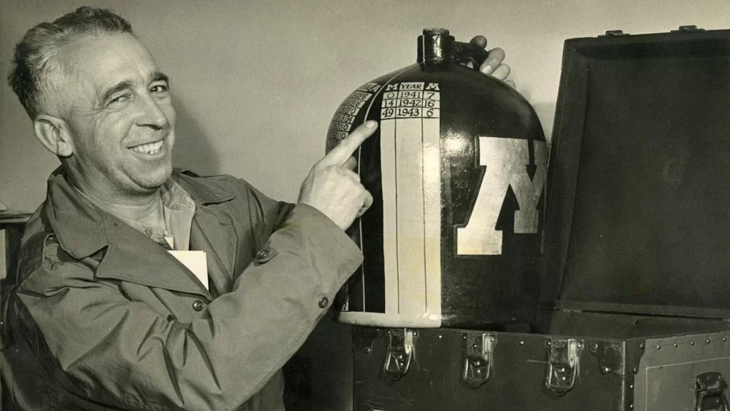 Henry Hatch, UM equipment manager, holding the Little Brown Jug in 1943.