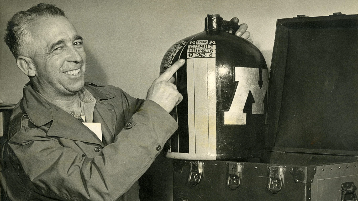 Henry Hatch, UM equipment manager, holding the Little Brown Jug in 1943.