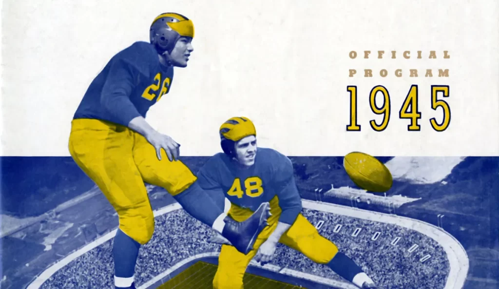 A 1945 University of Michigan football program shows football players wearing maize and blue uniforms cutout and super-imposed against the backdrop of the Michigan Stadium.