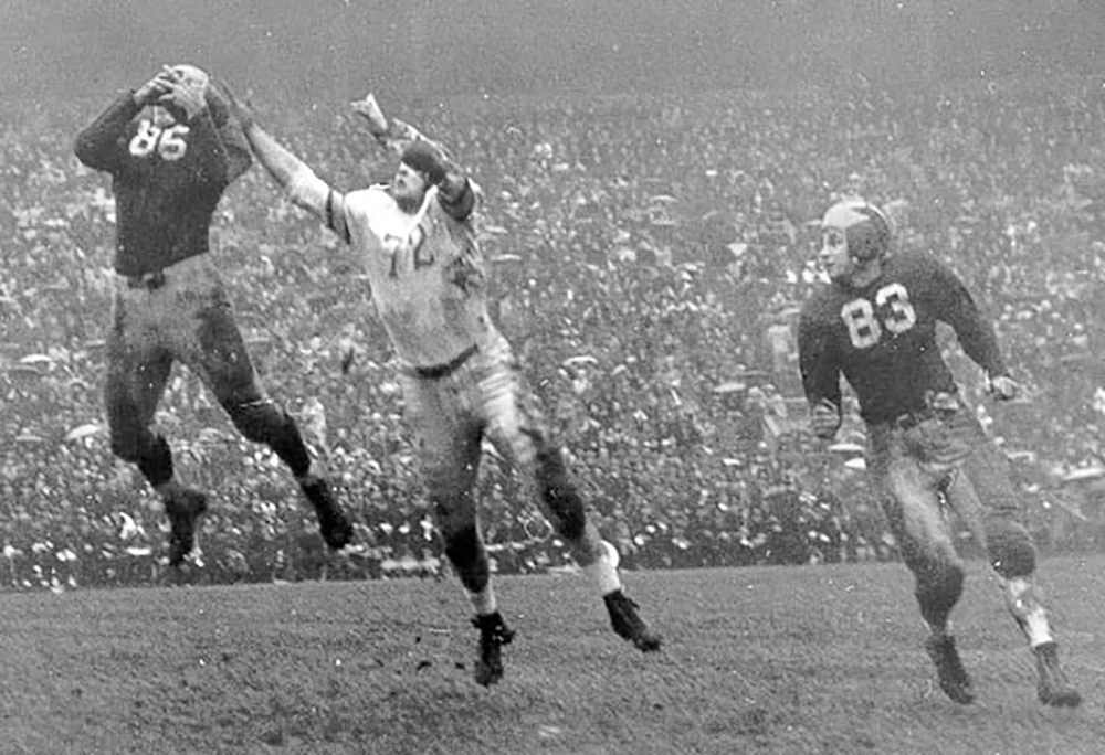 MIichigan’s stocky fullback goes high in the air to intercept Ohio pass