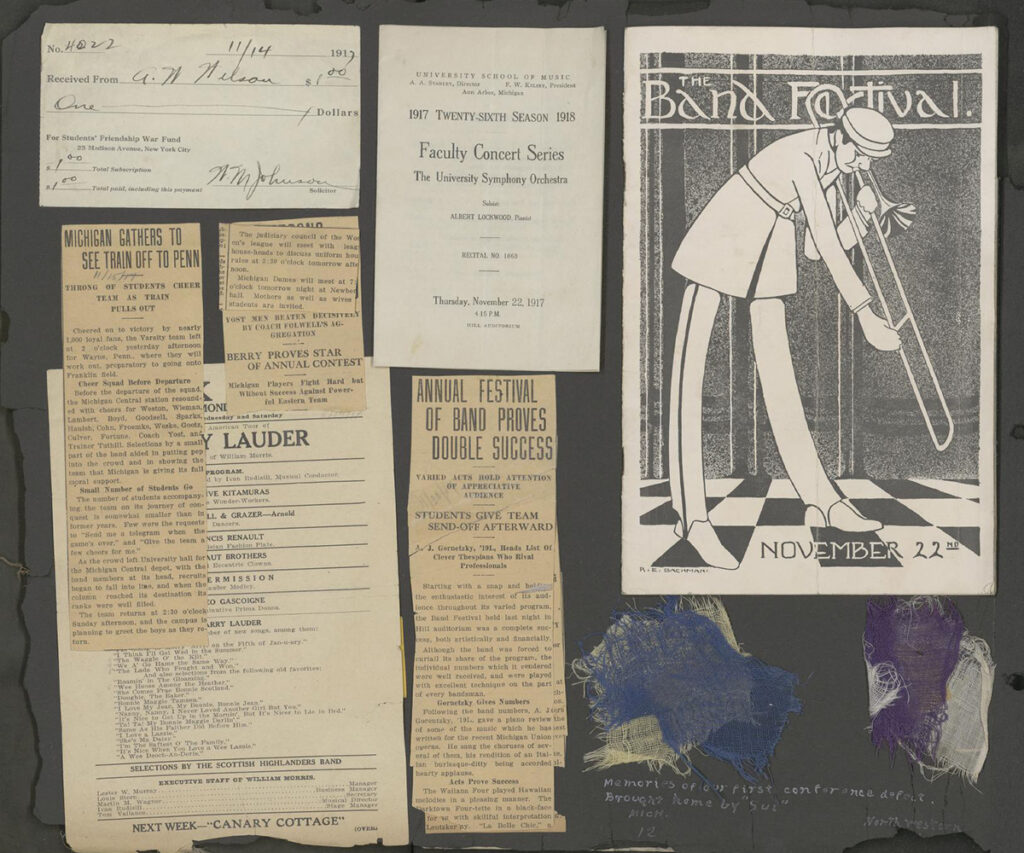 A black scrapbook page, on which is pasted old newspaper clippings as well as a black and white pamphlet advertising "The Band Festival."