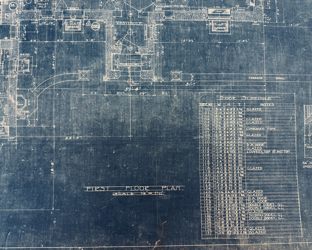 A dark blue architectural bluepring featuring writing and labels in white.