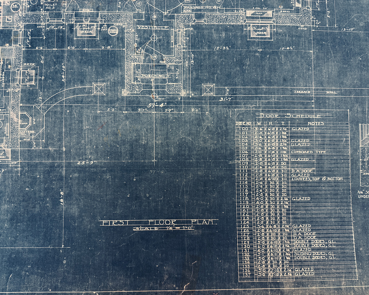 A dark blue architectural bluepring featuring writing and labels in white.