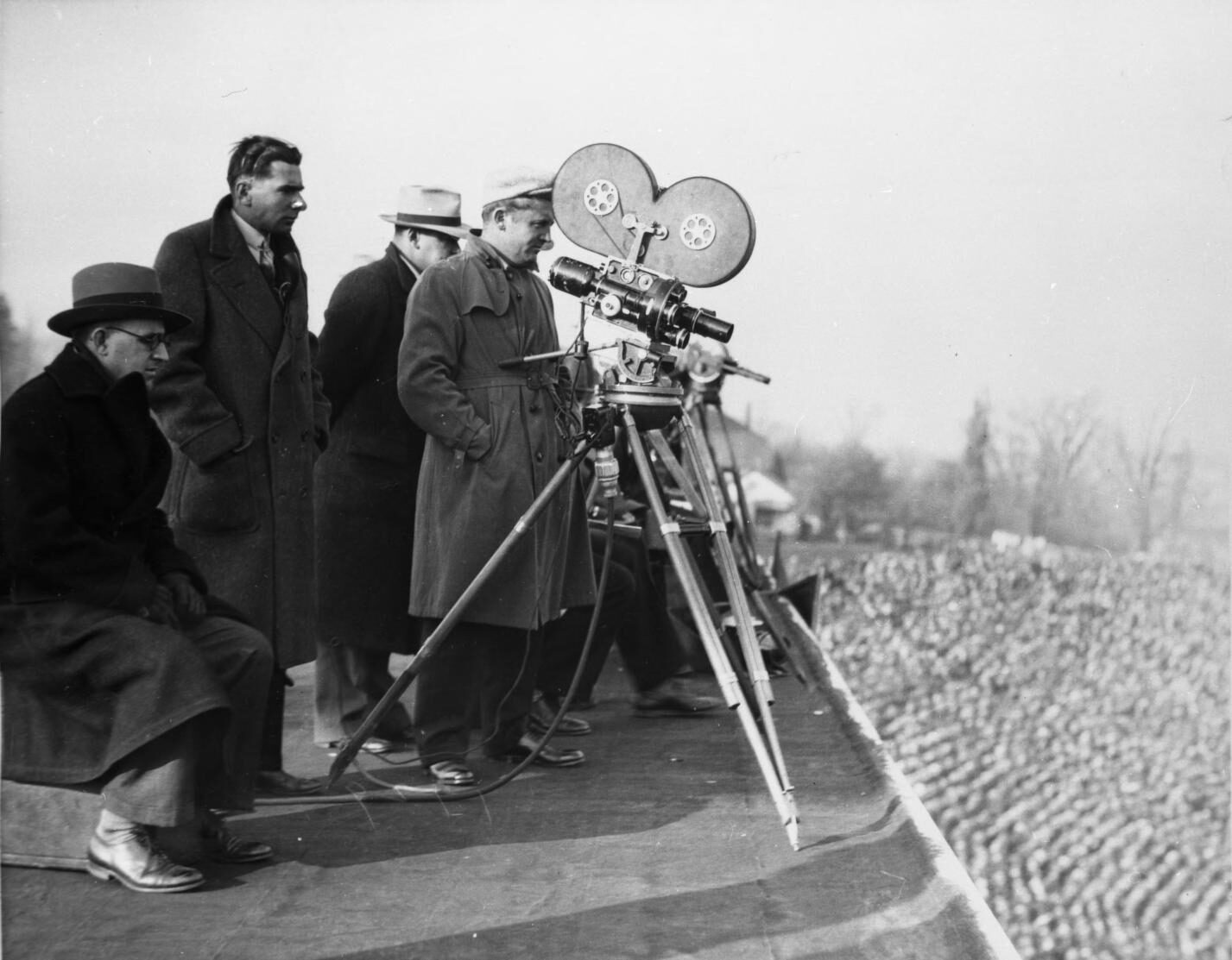 Photo of men operating camera at UM football game against Illinois, 1930.