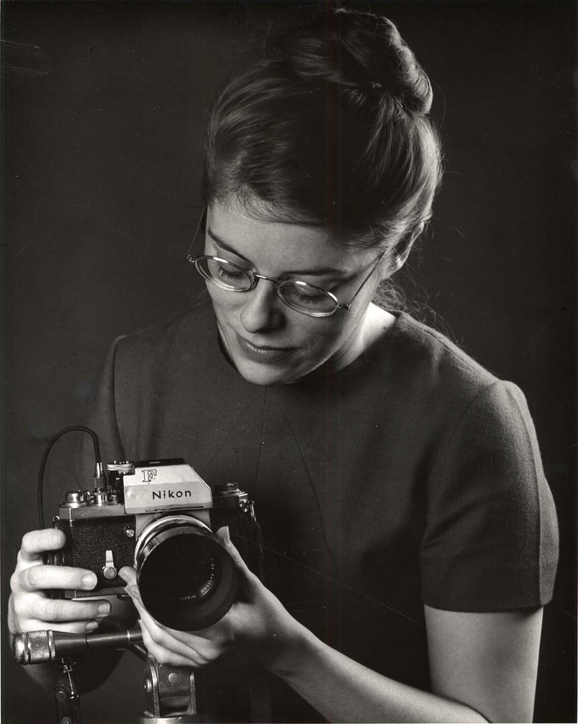 Photo of Virginia Geren, photographer for UM Photo Services, holding film camera.
