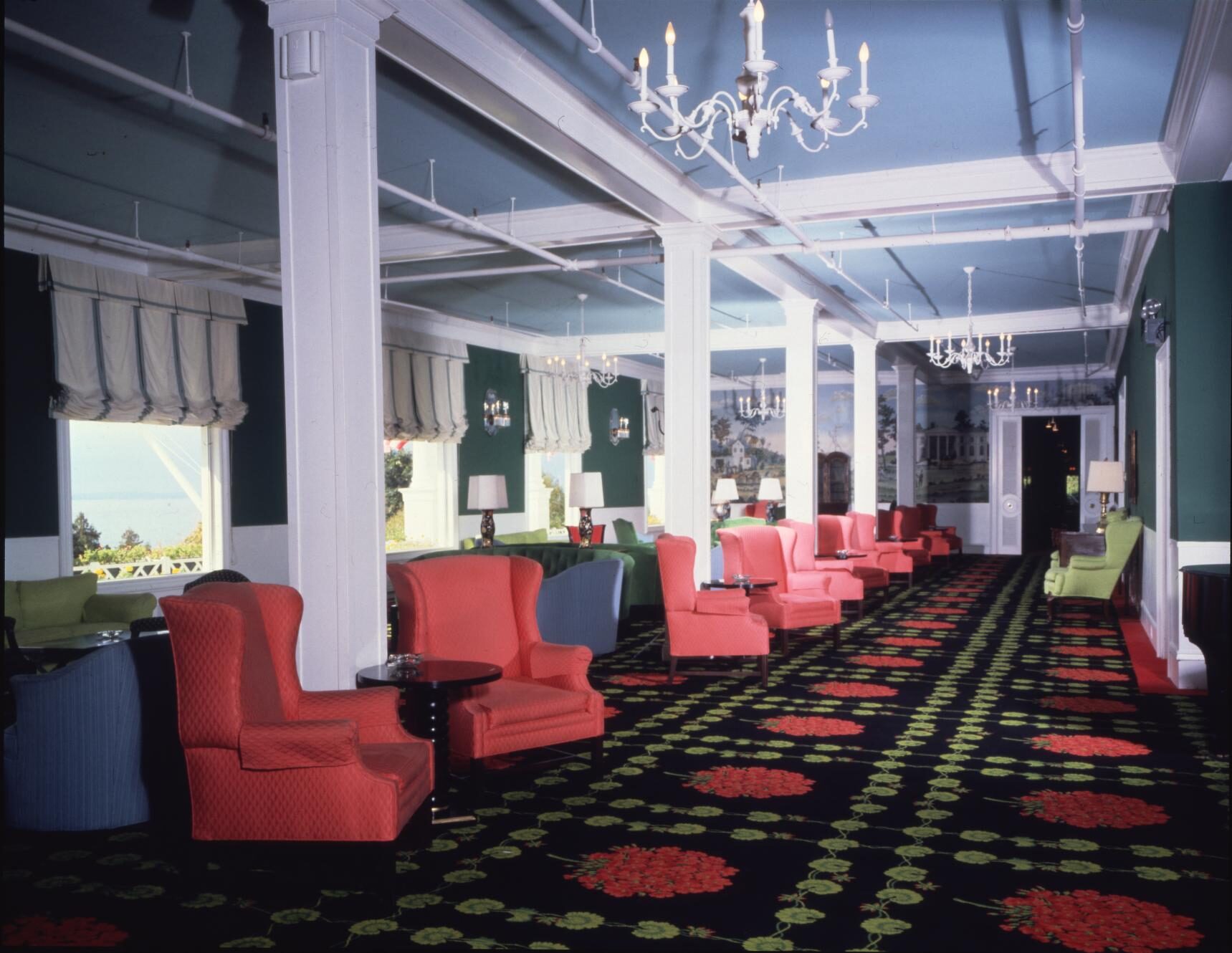 Photo of hotel interior with long row of red armchairs.